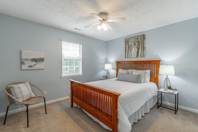 bedroom with baseboards, carpet flooring, ceiling fan, and a textured ceiling