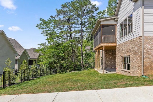 view of yard with a sunroom and a patio area