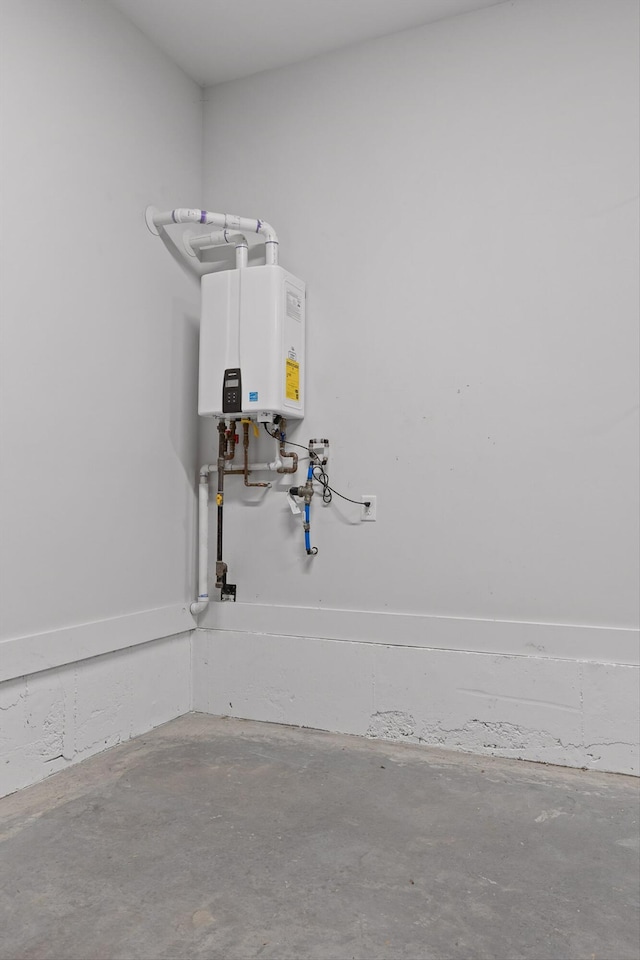 utility room featuring tankless water heater
