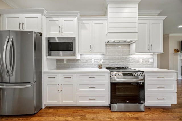 2664 Mowbray Pike Unit 2, Soddy Daisy, TN 37379 - kitchen featuring stainless steel appliances, custom exhaust hood, light countertops, crown molding, and white cabinets