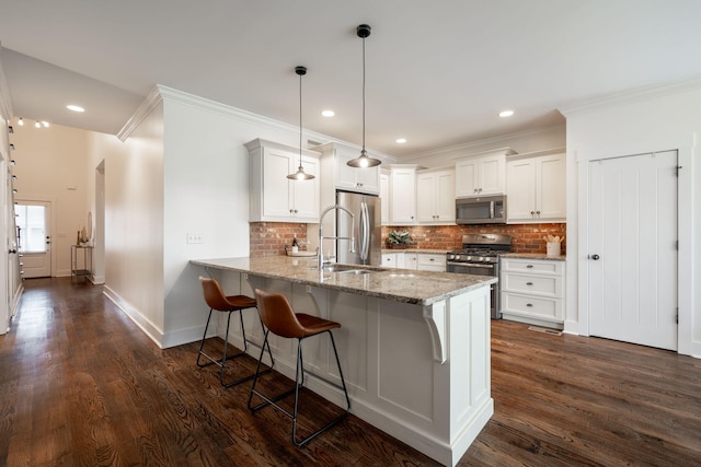 3637 Stickley Way, Apison, TN 37302 - kitchen with appliances with stainless steel finishes, a sink, a peninsula, ornamental molding, and a kitchen breakfast bar