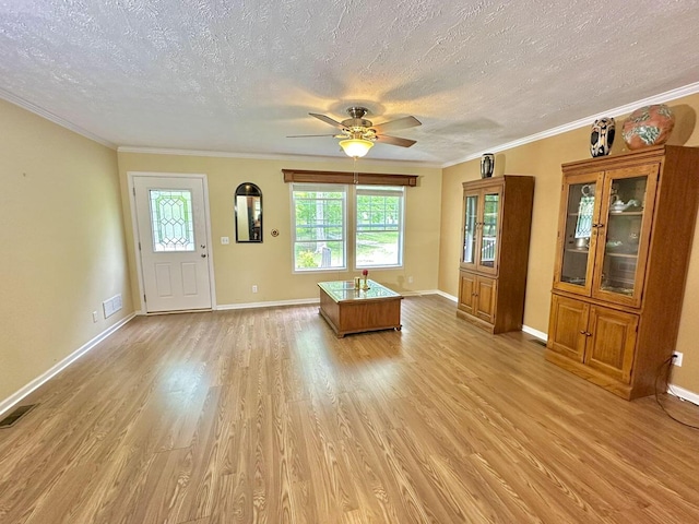 2218 Harvest Ln, Dandridge, TN 37725 - unfurnished living room with a textured ceiling, light wood finished floors, ceiling fan, baseboards, and ornamental molding