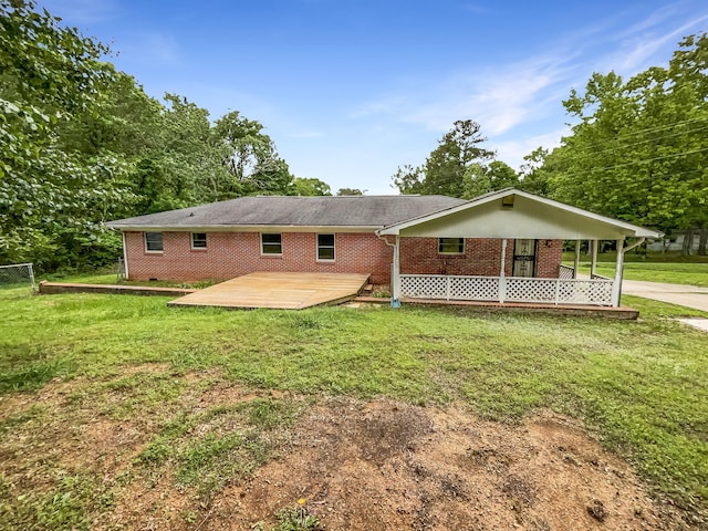 back of house featuring brick siding and a deck