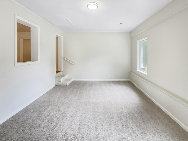 carpeted empty room featuring baseboards