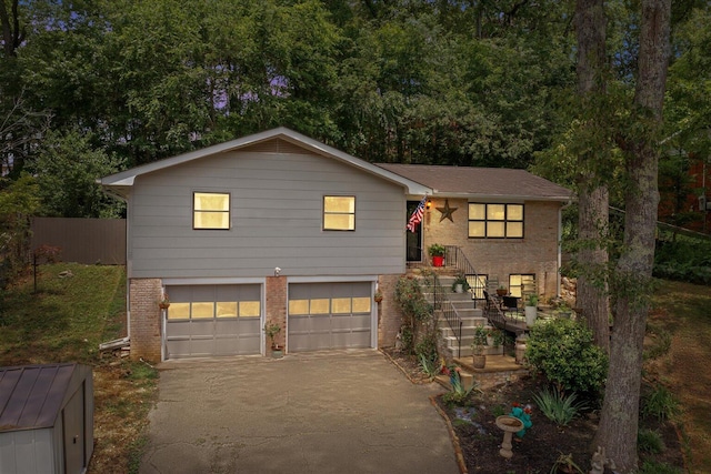 209 Cinderella Dr, Flintstone, GA 30725 - split level home with brick siding, an attached garage, and asphalt driveway