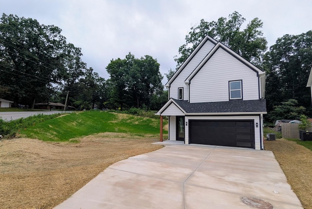 9162 Fuller Rd, Chattanooga, TN 37421 - view of property exterior with an attached garage, concrete driveway, a lawn, and roof with shingles
