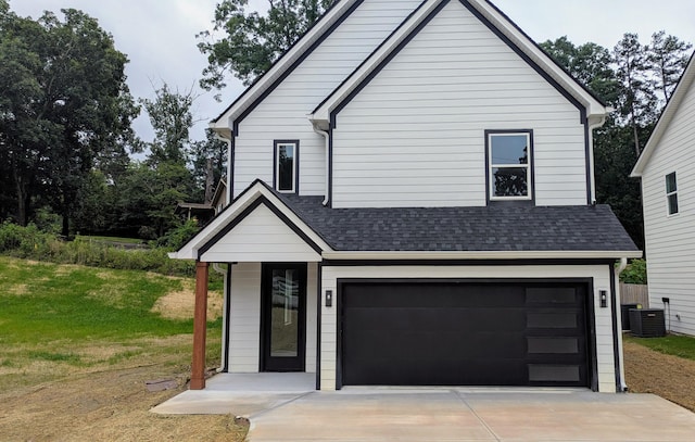 9162 Fuller Rd, Chattanooga, TN 37421 - view of front of property featuring a garage, concrete driveway, roof with shingles, and a front lawn