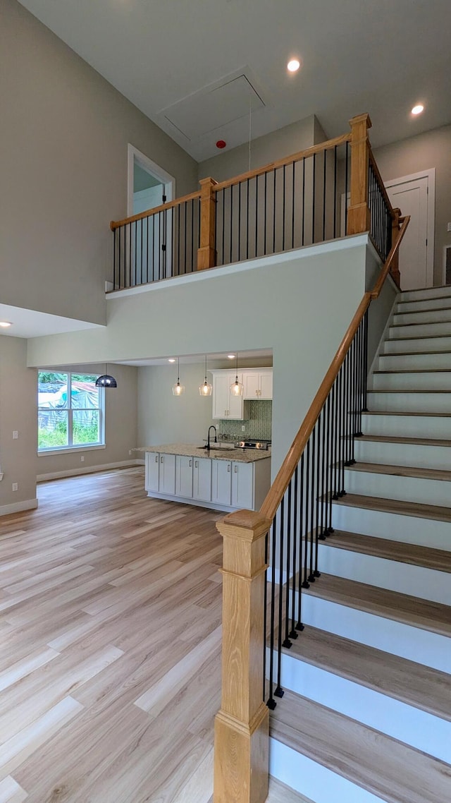 9162 Fuller Rd, Chattanooga, TN 37421 - staircase featuring attic access, a high ceiling, wood finished floors, and recessed lighting