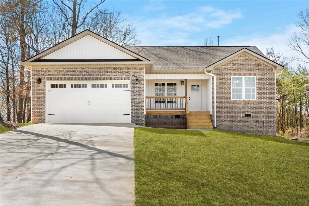 118 Earls Way, Chatsworth, GA 30705 - single story home with brick siding, covered porch, concrete driveway, and a front lawn