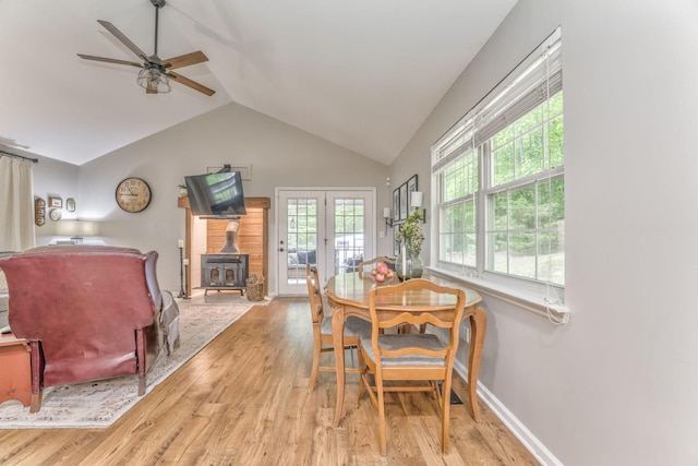 4950 Standifer Rd, Cohutta, GA 30710 - dining space with light wood-style flooring, a wood stove, vaulted ceiling, ceiling fan, and french doors