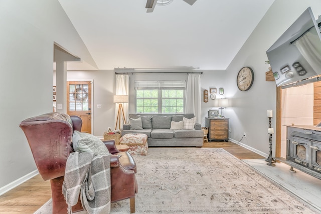 4950 Standifer Rd, Cohutta, GA 30710 - living area with wood finished floors, vaulted ceiling, a ceiling fan, a wood stove, and baseboards