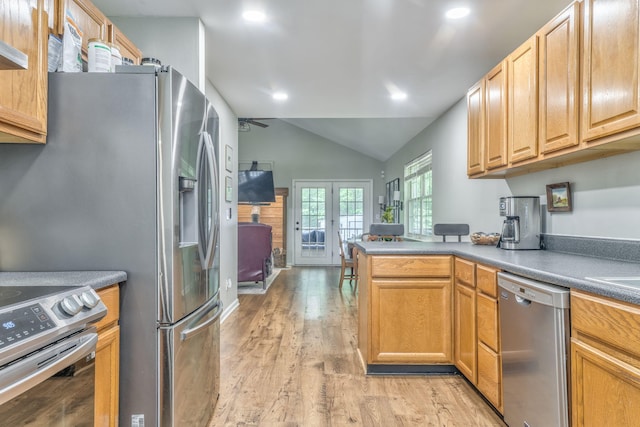 4950 Standifer Rd, Cohutta, GA 30710 - kitchen with appliances with stainless steel finishes, vaulted ceiling, french doors, light wood finished floors, and a peninsula