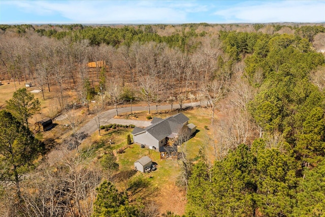 view of subject property with a forest