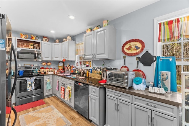 132 Katie Ln, Chatsworth, GA 30705 - kitchen featuring appliances with stainless steel finishes, dark countertops, light wood-type flooring, and recessed lighting
