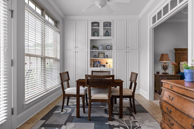 dining room featuring ceiling fan, ornamental molding, and baseboards