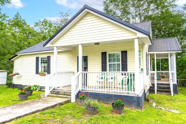 301 Cedar St, Lafayette, GA 30728 - view of front of home featuring covered porch, metal roof, and a front yard