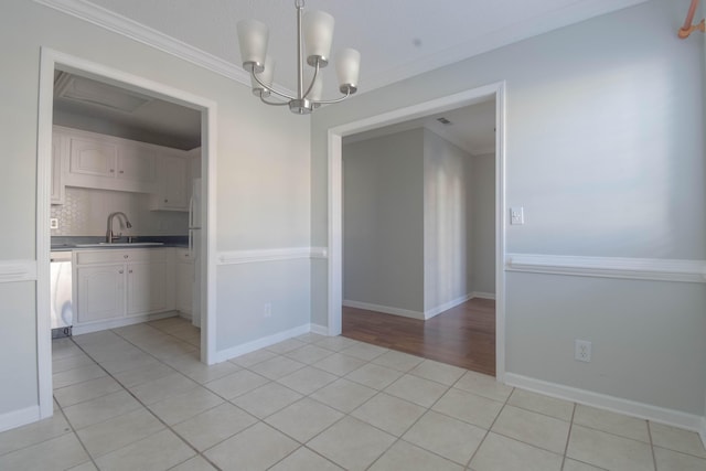 2204 Old Ivy Way Apt 3, Dalton, GA 30720 - unfurnished dining area featuring a sink, a chandelier, ornamental molding, light tile patterned flooring, and washer / dryer
