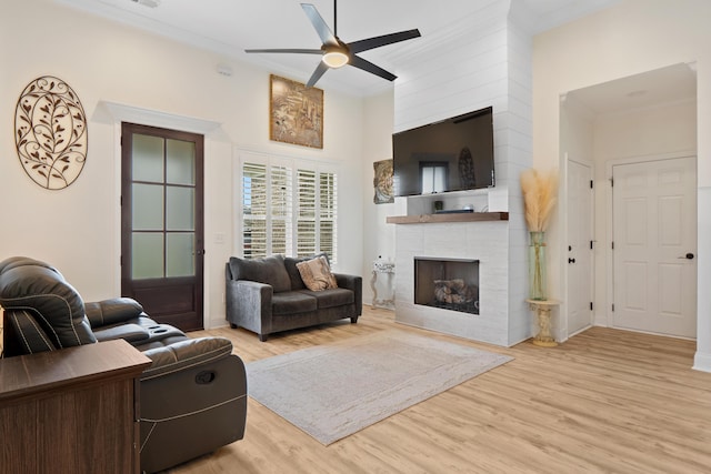 5834 Caney Ridge Cir, Ooltewah, TN 37363 - living room featuring ceiling fan, a fireplace, wood finished floors, crown molding, and a high ceiling