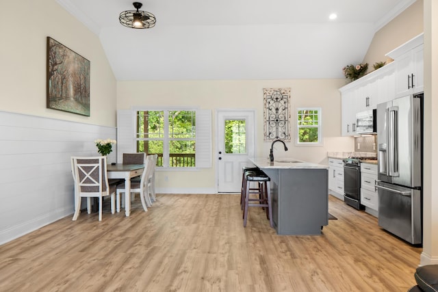 5834 Caney Ridge Cir, Ooltewah, TN 37363 - kitchen featuring high end refrigerator, gas stove, lofted ceiling, a kitchen bar, and a sink