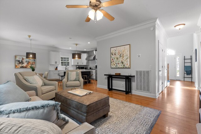 715 Forest Ave, Chattanooga, TN 37405 - living room featuring ornamental molding, recessed lighting, light wood-type flooring, a ceiling fan, and baseboards