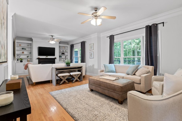 715 Forest Ave, Chattanooga, TN 37405 - living room featuring a ceiling fan, ornamental molding, light wood finished floors, built in shelves, and baseboards