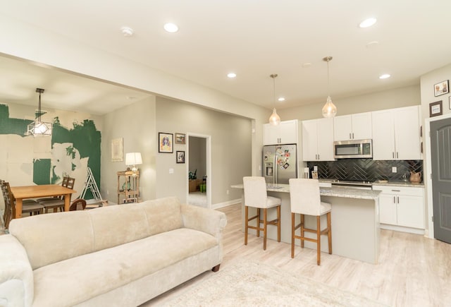 714 W 42nd St, Chattanooga, TN 37410 - living room with light wood-type flooring, recessed lighting, and baseboards