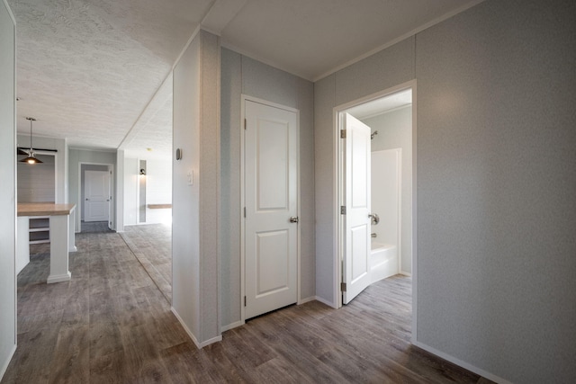 hall featuring dark wood-style floors and baseboards