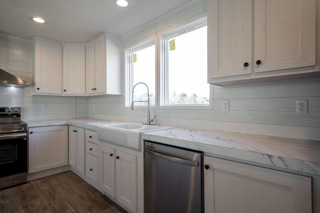 kitchen with stainless steel appliances, light countertops, white cabinets, recessed lighting, and dark wood finished floors