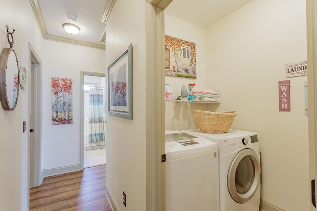 634 Gadd Rd, Hixson, TN 37343 - clothes washing area with washing machine and dryer, wood finished floors, baseboards, and ornamental molding