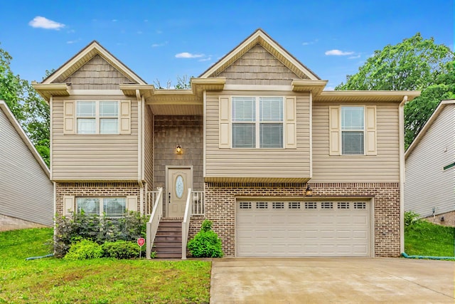 634 Gadd Rd, Hixson, TN 37343 - view of front facade featuring brick siding, an attached garage, driveway, and a front lawn