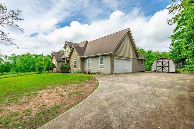 13709 Stormer Rd, Soddy Daisy, TN 37379 - view of front of home featuring a shed, a front yard, concrete driveway, roof with shingles, and an outbuilding