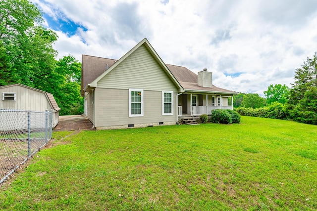 13709 Stormer Rd, Soddy Daisy, TN 37379 - rear view of house with covered porch, a chimney, crawl space, and an outbuilding