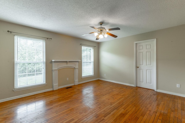 13709 Stormer Rd, Soddy Daisy, TN 37379 - unfurnished living room featuring a ceiling fan, light wood finished floors, a textured ceiling, and baseboards