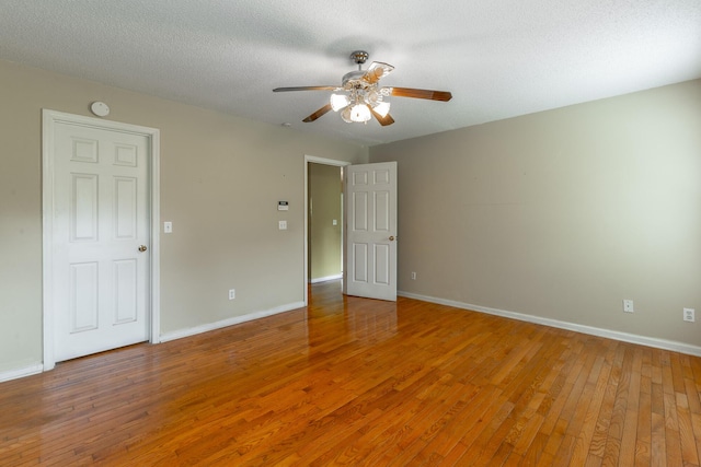 13709 Stormer Rd, Soddy Daisy, TN 37379 - empty room with light wood-type flooring, ceiling fan, baseboards, a smoke detector, and a textured ceiling