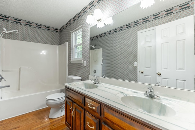 13709 Stormer Rd, Soddy Daisy, TN 37379 - full bathroom featuring wood finished floors, toilet, shower / bathtub combination, wallpapered walls, and double vanity