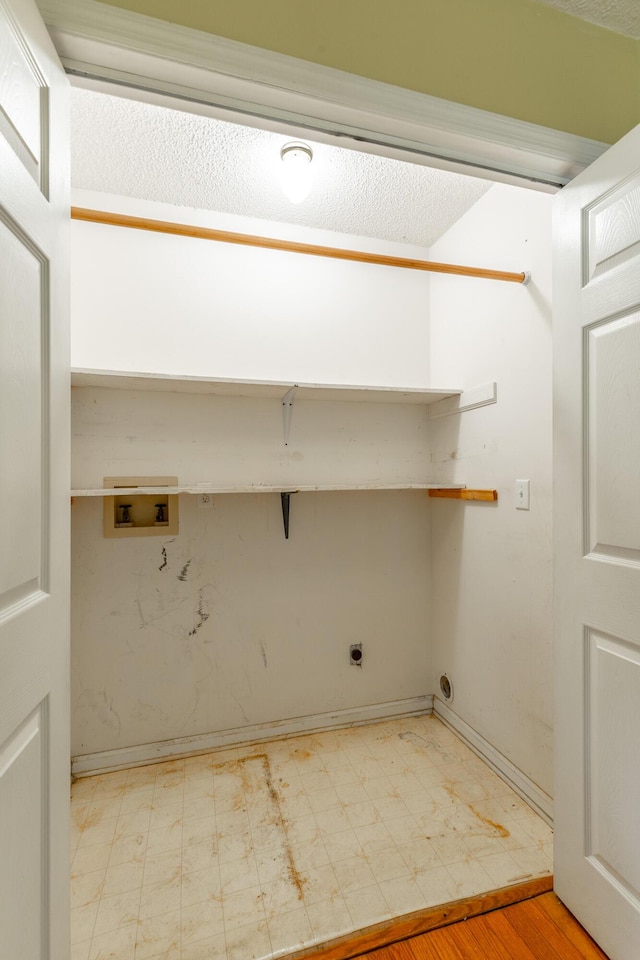 13709 Stormer Rd, Soddy Daisy, TN 37379 - laundry area with electric dryer hookup, hookup for a washing machine, light flooring, and baseboards