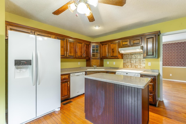 13709 Stormer Rd, Soddy Daisy, TN 37379 - kitchen with white appliances, a sink, under cabinet range hood, light wood-style floors, and a textured ceiling