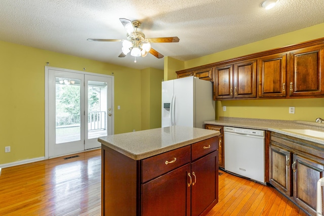 13709 Stormer Rd, Soddy Daisy, TN 37379 - kitchen featuring white appliances, a sink, light wood-style floors, a ceiling fan, and a textured ceiling