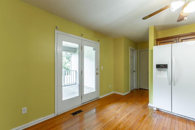 13709 Stormer Rd, Soddy Daisy, TN 37379 - kitchen with white refrigerator with ice dispenser, light wood-style flooring, ceiling fan, and baseboards
