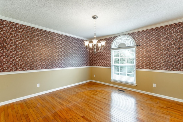 13709 Stormer Rd, Soddy Daisy, TN 37379 - unfurnished room with wallpapered walls, a chandelier, hardwood / wood-style floors, baseboards, and a textured ceiling