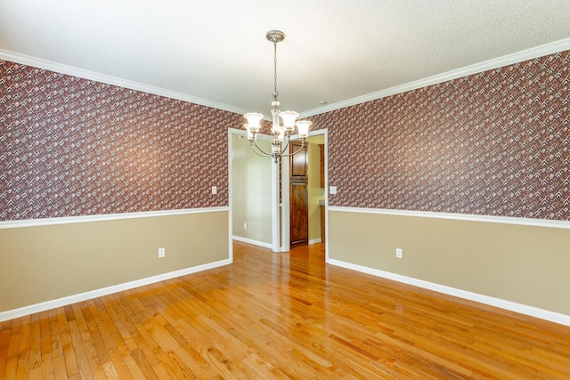 13709 Stormer Rd, Soddy Daisy, TN 37379 - unfurnished room with wallpapered walls, a chandelier, wood finished floors, baseboards, and crown molding