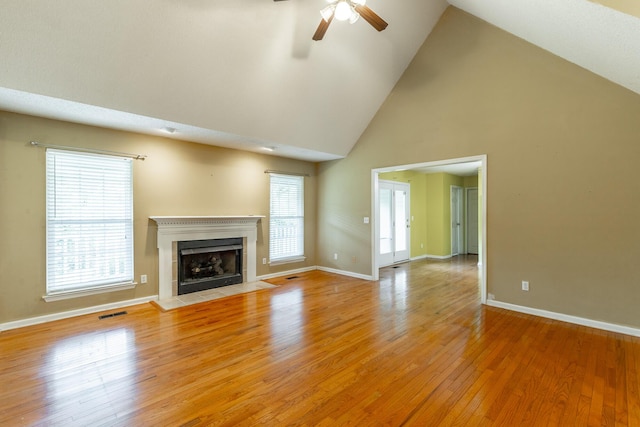 13709 Stormer Rd, Soddy Daisy, TN 37379 - unfurnished living room with high vaulted ceiling, ceiling fan, a fireplace, light wood-style flooring, and baseboards