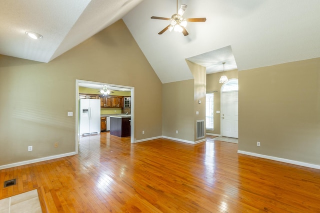 13709 Stormer Rd, Soddy Daisy, TN 37379 - unfurnished living room with a ceiling fan, high vaulted ceiling, light wood-type flooring, and baseboards