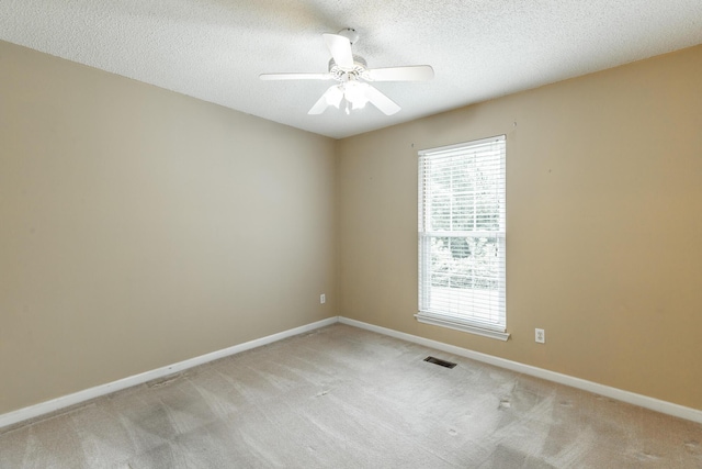 13709 Stormer Rd, Soddy Daisy, TN 37379 - unfurnished room with light carpet, baseboards, ceiling fan, and a textured ceiling