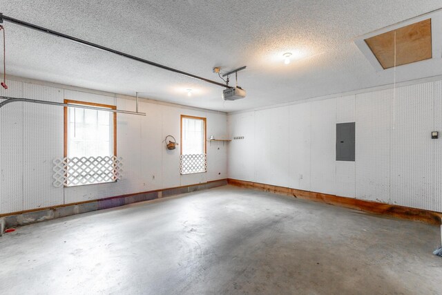 13709 Stormer Rd, Soddy Daisy, TN 37379 - garage featuring electric panel, a garage door opener, and baseboards