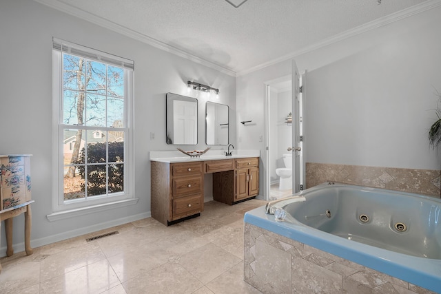 bathroom with toilet, ornamental molding, a whirlpool tub, vanity, and a textured ceiling