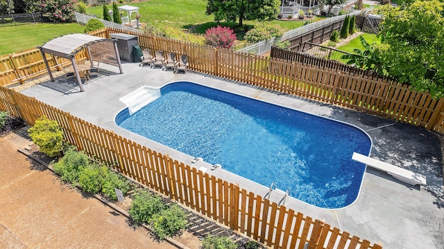 view of pool featuring a patio area and a diving board