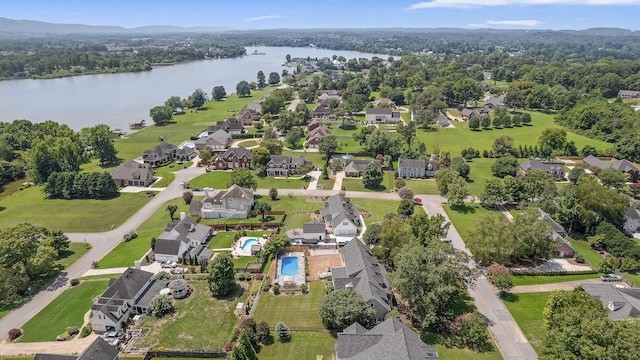 view of property location featuring a nearby body of water, nearby suburban area, and a pool