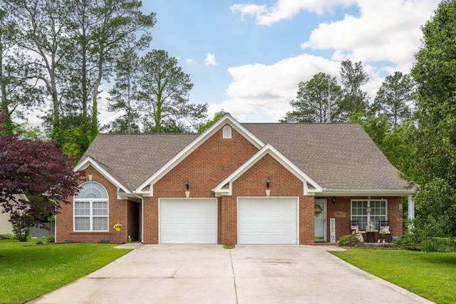 view of front of home with concrete driveway, an attached garage, a front lawn, and brick siding