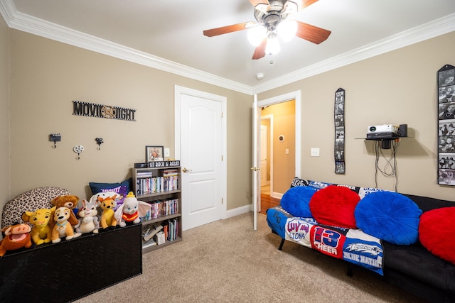 playroom with ornamental molding, carpet flooring, a ceiling fan, and baseboards